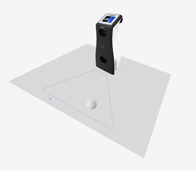 Overhead view showing where to place the ball. A triangular hit zone, outlined with a dotted line, sits on the ground directly in front of the GC2's cameras. The narrow point of the triangle starts at the front of the device and the zone widens as it extends away. One edge of the zone measures 16 inches. Place the ball inside this triangle, in front of the cameras, for the GC2 to detect it and capture the shot.