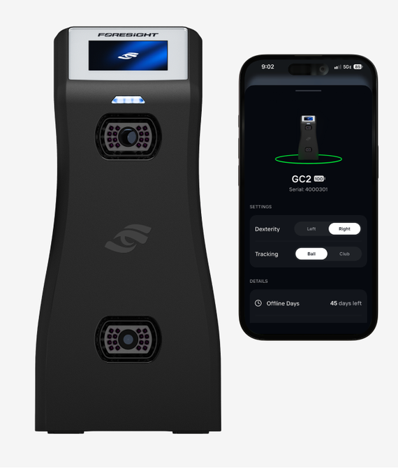 The GC2 launch monitor next to a phone running the Foresight App, showing how device settings are managed from the app and not on the GC2 itself. The GC2's display shows the Foresight logo and its Status Light is blue. The app's device screen shows the connected GC2 with its battery at 100% and its serial number. Under Settings, Dexterity is set to Right (options: Left or Right) and Tracking is set to Ball (options: Ball or Club). Under Details, Offline Days shows 45 days left before the GC2 must connect to the internet to validate its registration.